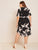 Plus Notch Neck Belted Curved Hem Crane Print Dress